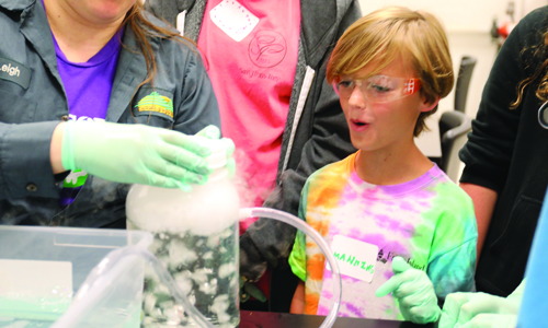 Boy with goggles at a STEM workshop