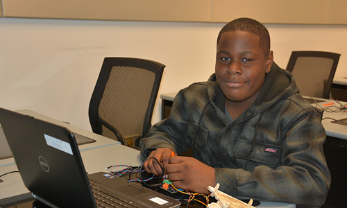 Student with micro controller and computer