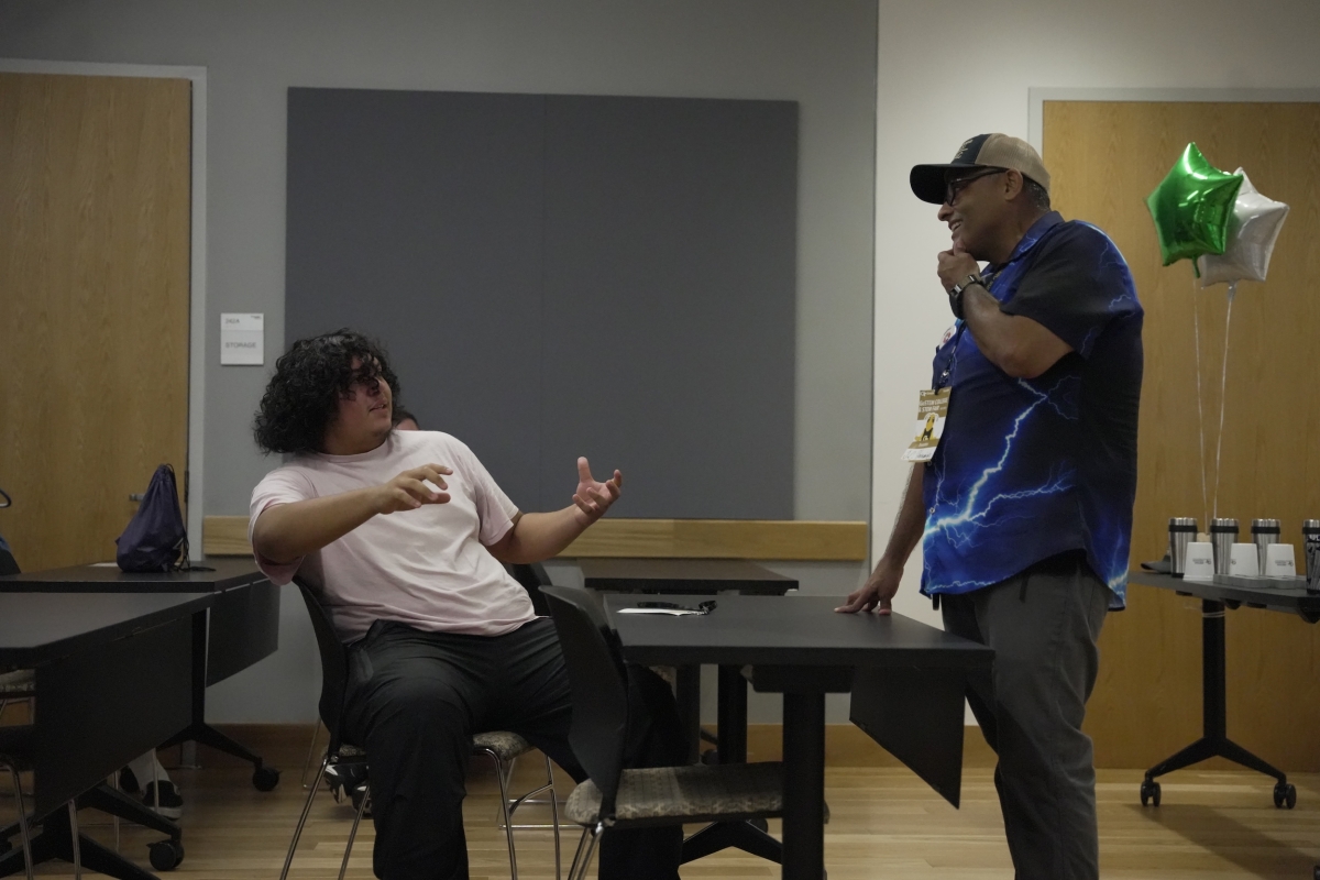 Image of K-12 learner discussing electricity with a Georgia Tech professor.