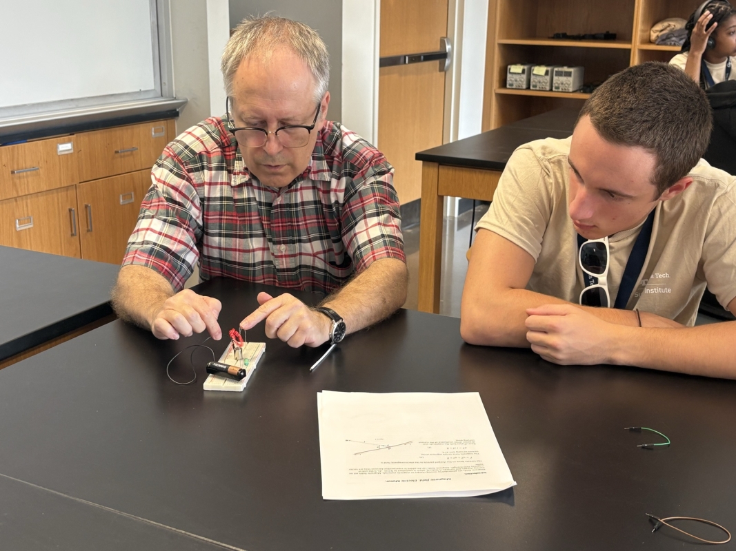 Image of Case Johnson watching a demonstration in a science lab.