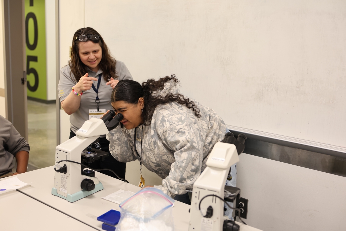 Image of K-12 learner looking through a microscope.