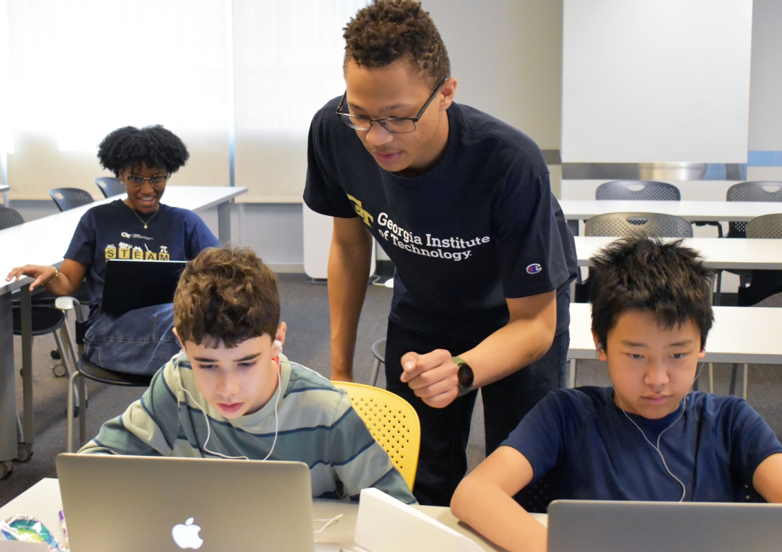 Johnathan Cunningham helped middle schoolers during the STEAM Workshop as they learned to code and create music.