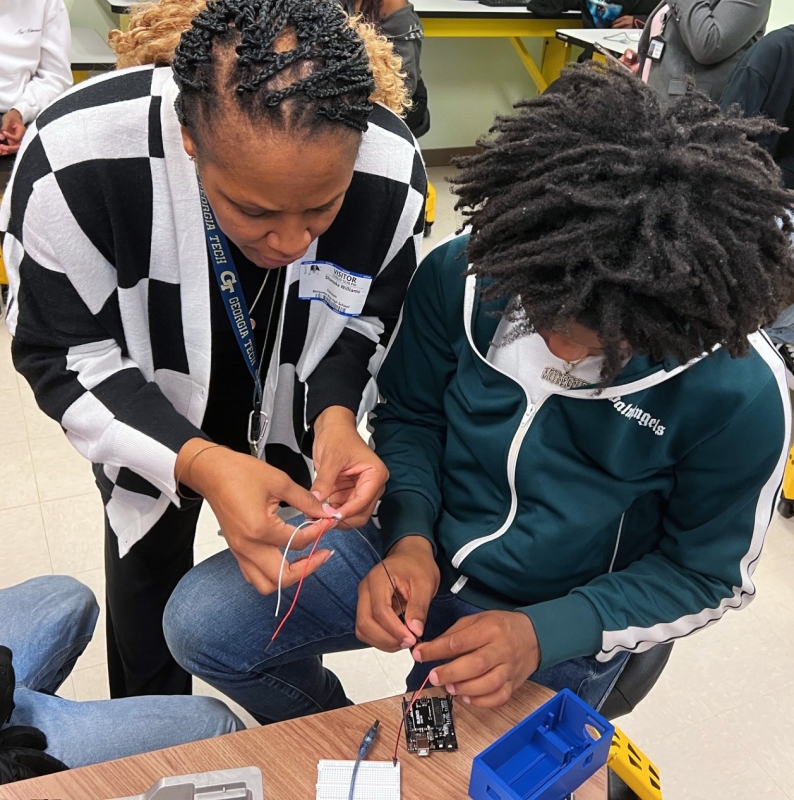 CEISMC's Shameka Williams is helping a student during a technology-focused lesson of the urban heat islands curriculum.
